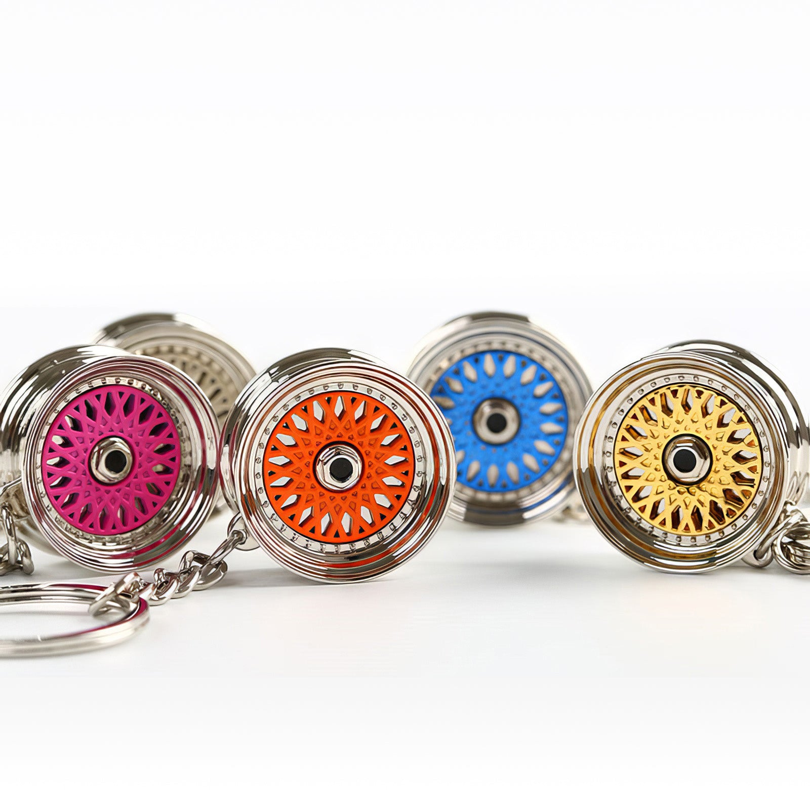 BBS Mesh Wheel keychains with pink, orange, blue, and gold center.