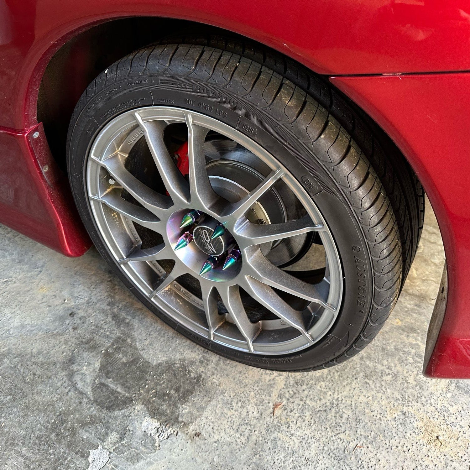 BLOX Spike Lug Nuts 50mm mounted on car wheels.