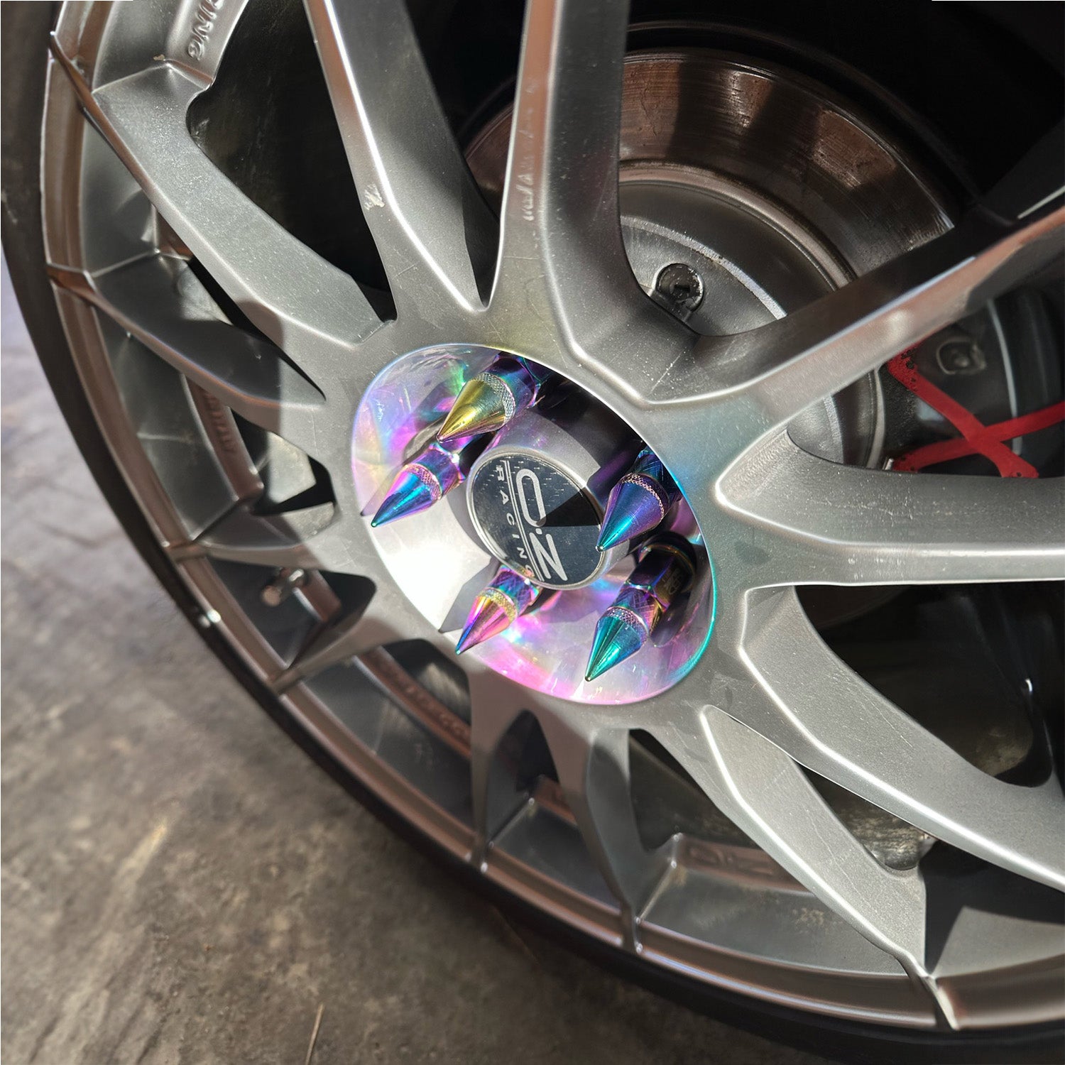 BLOX Spike Lug Nuts 50mm mounted on car wheels.