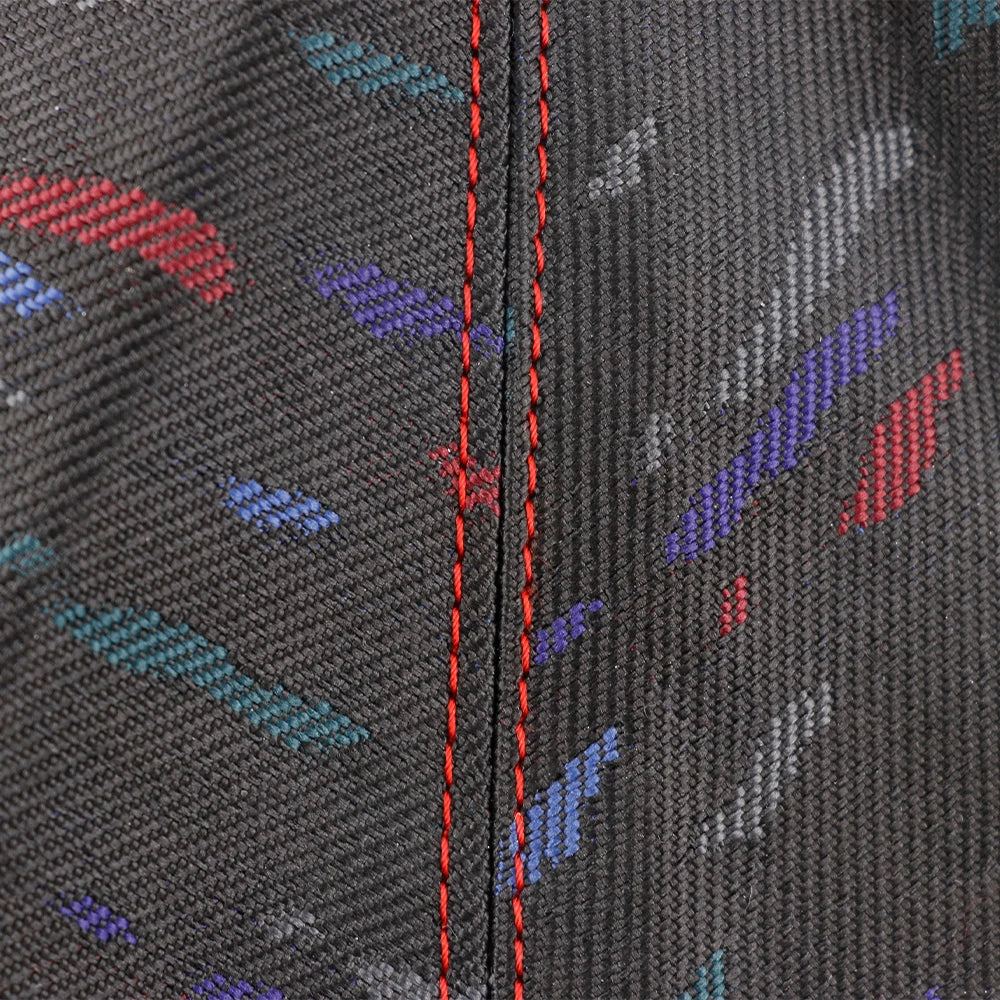 Black gear shift cover with colorful pattern on a white background