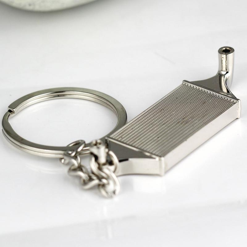 Intercooler car keychain in chrome finish on a desktop.