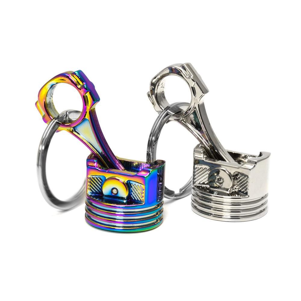 Piston car keychains in silver and neochrome finish.