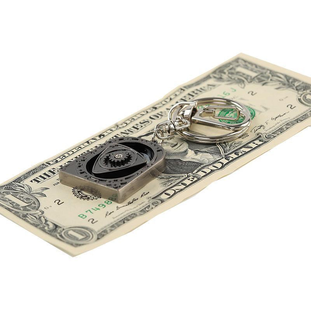 Wankel rotary engine car keychain on a surface.