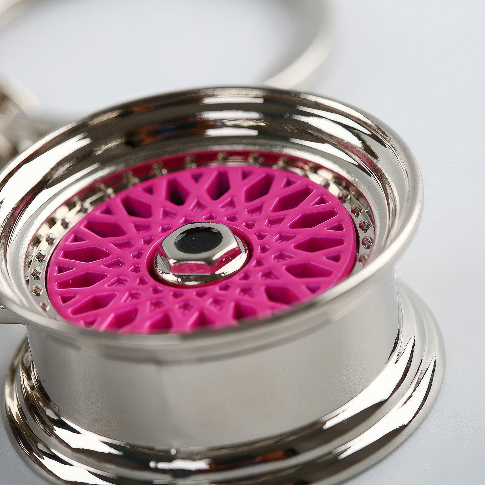 BBS Mesh Wheel keychain with pink center.