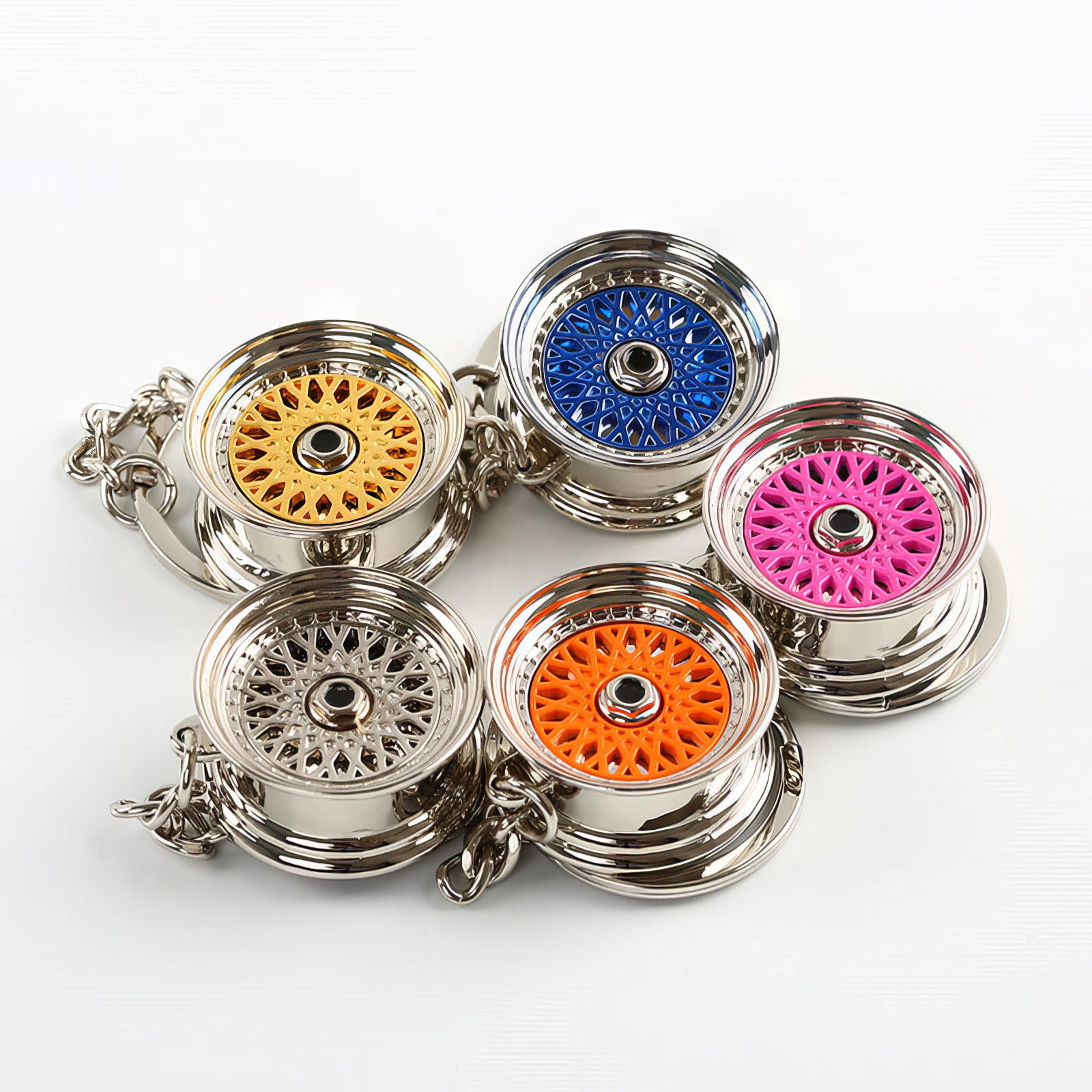 BBS Mesh Wheel keychains with pink, orange, blue, and gold center.