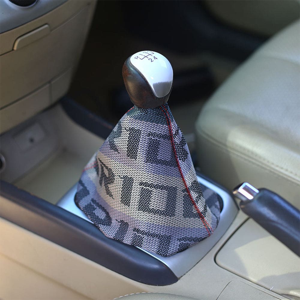 Bride racing JDM gear shift boot cover in beige gradient mounted in car. 