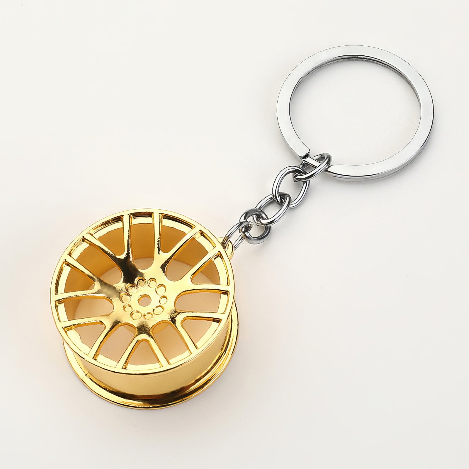Concave wheel keychain in gold.