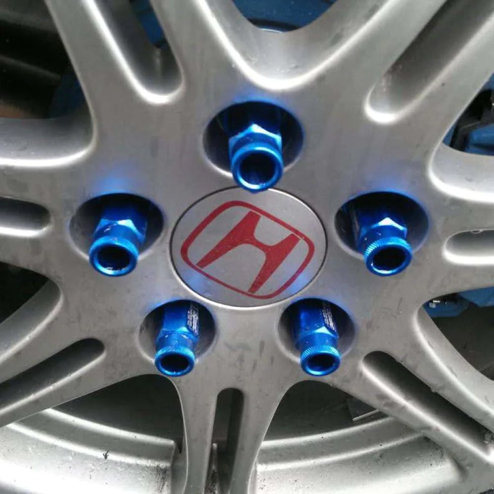 D1 Spec Racing Lug Nuts 52mm in blue mounted on car wheel. 