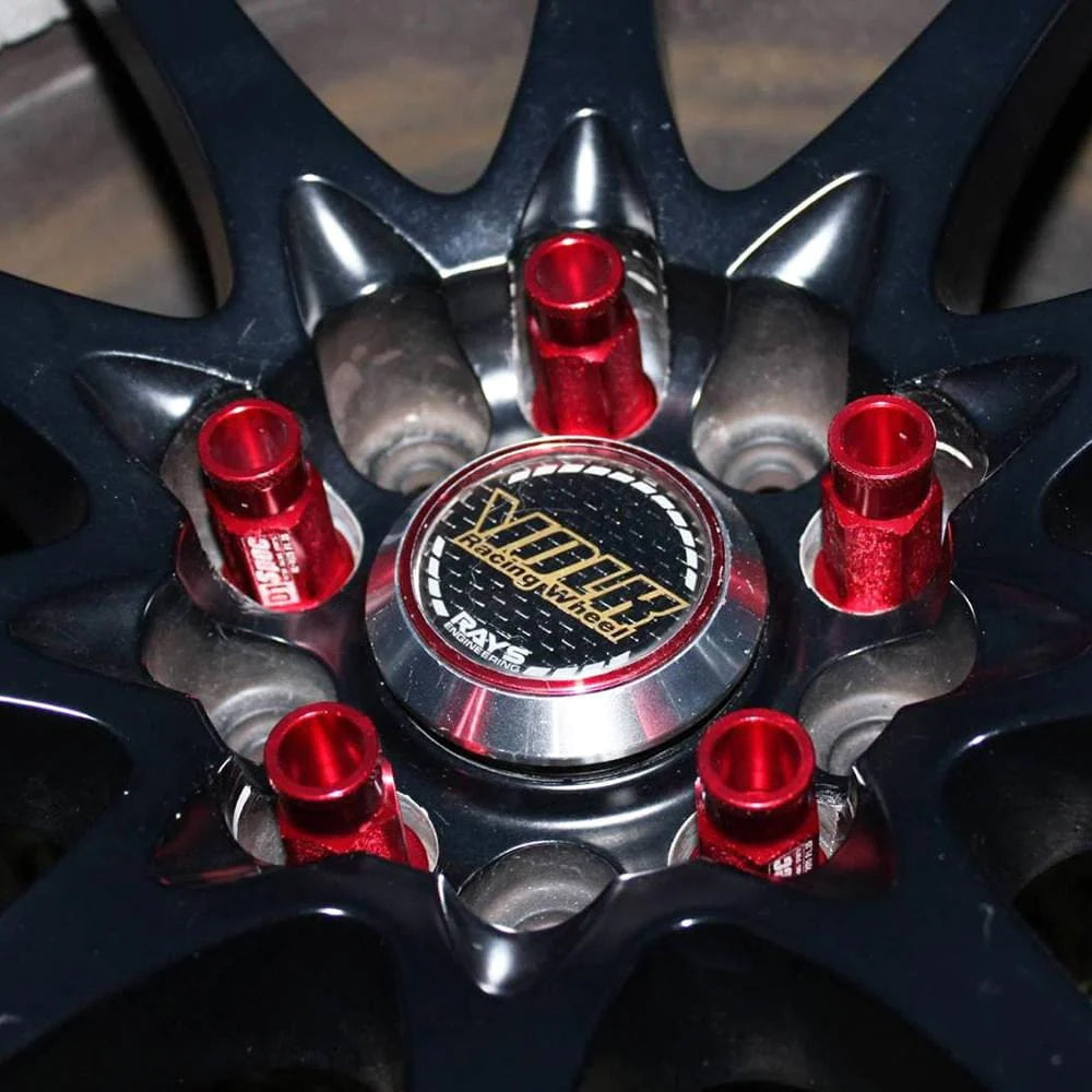D1 Spec Racing Lug Nuts 52mm in red mounted on car wheel.