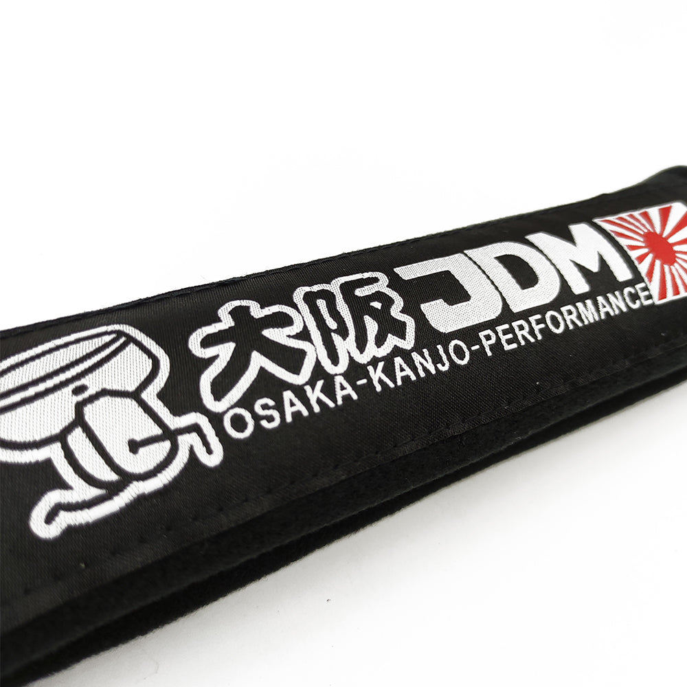 JDM Osaka Kanjo seat belt shoulder pads in black details.