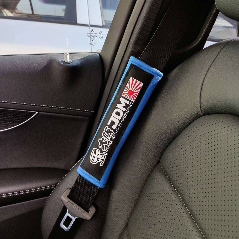 JDM Osaka Kanjo seat belt shoulder pads in blue installed in car.