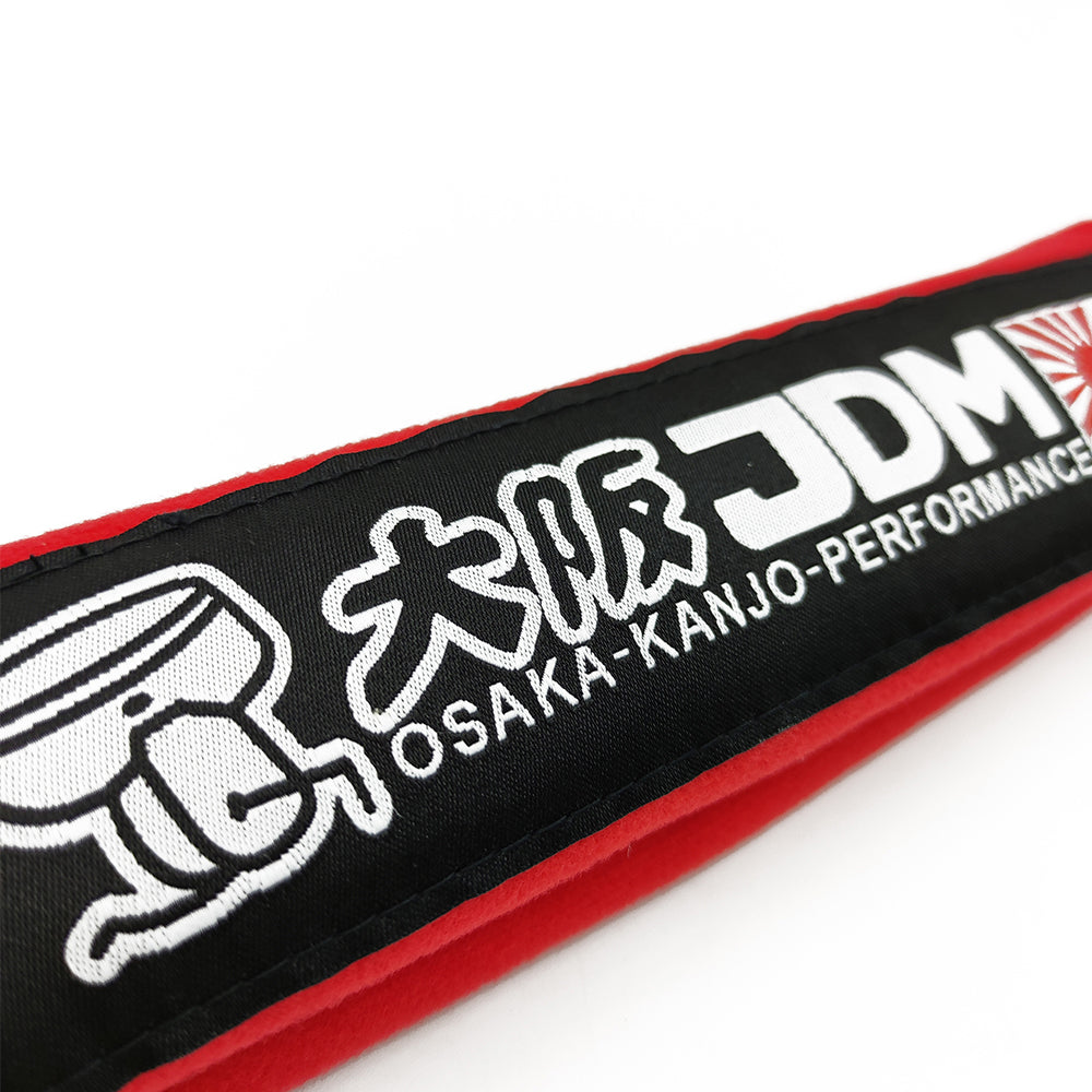 JDM Osaka Kanjo seat belt shoulder pads in red details.