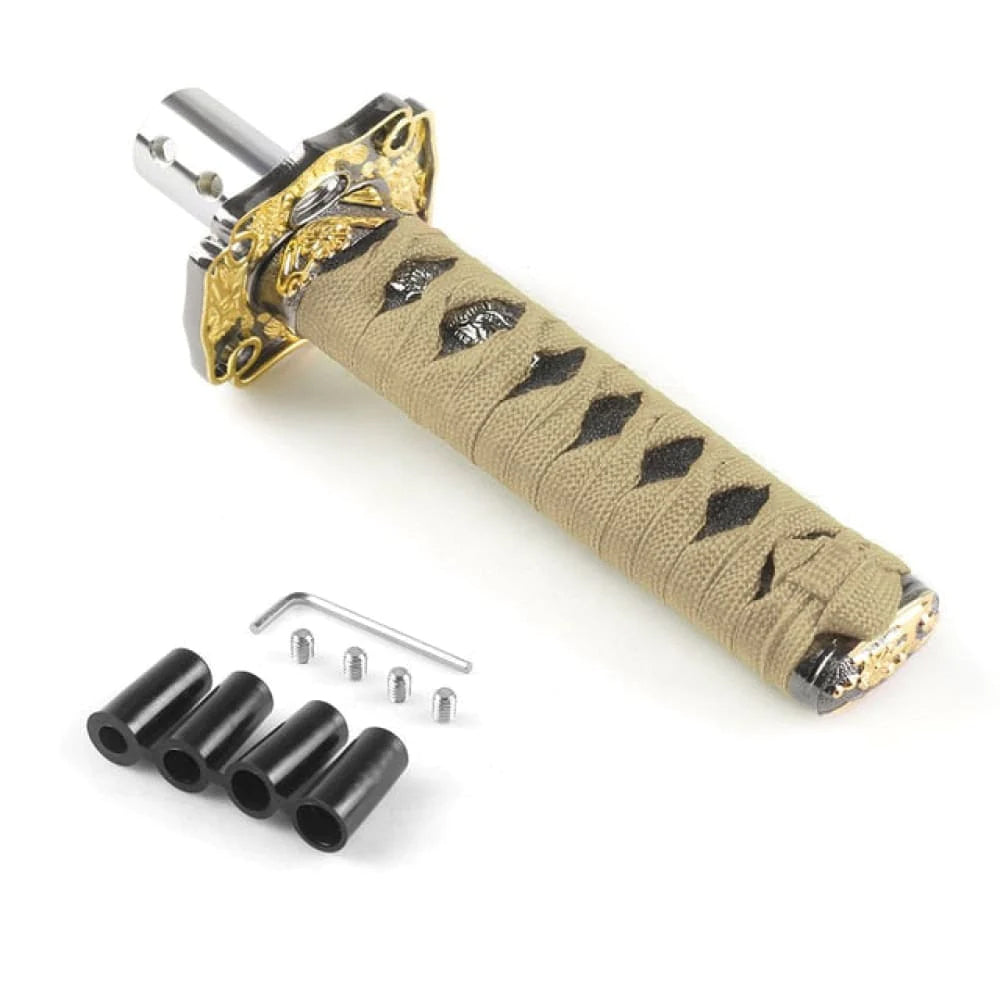 https://tunerlifestyle.com/cdn/shop/files/katana-samurai-sword-shift-knob-gold-black-15cm.jpg?v=1688572274&width=1000