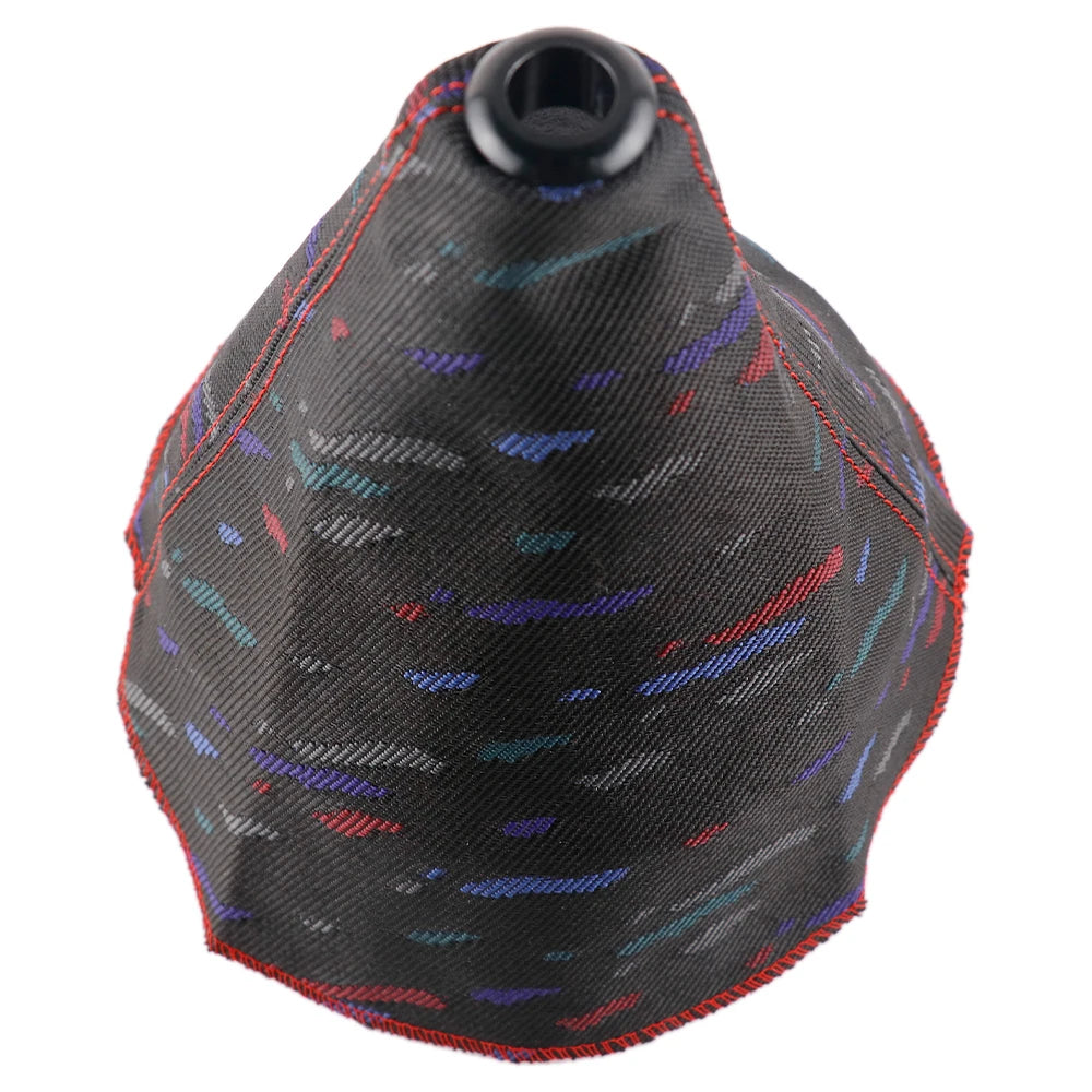 Black gear shift cover with colorful pattern on a white background