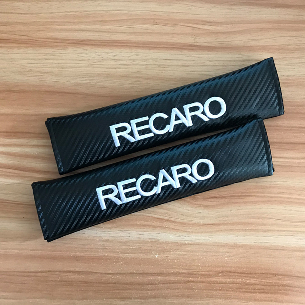 Recaro carbon style seat belt shoulder pads. 