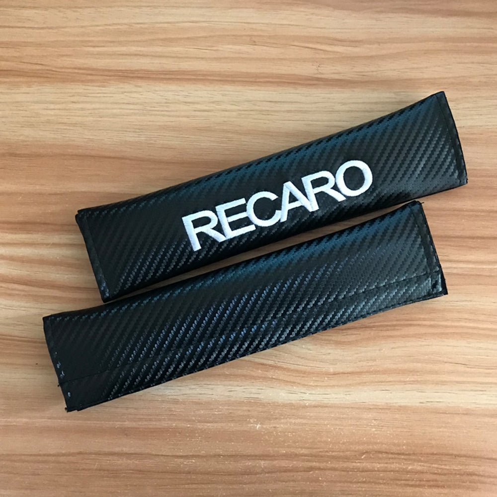 Recaro carbon style seat belt shoulder pads. 