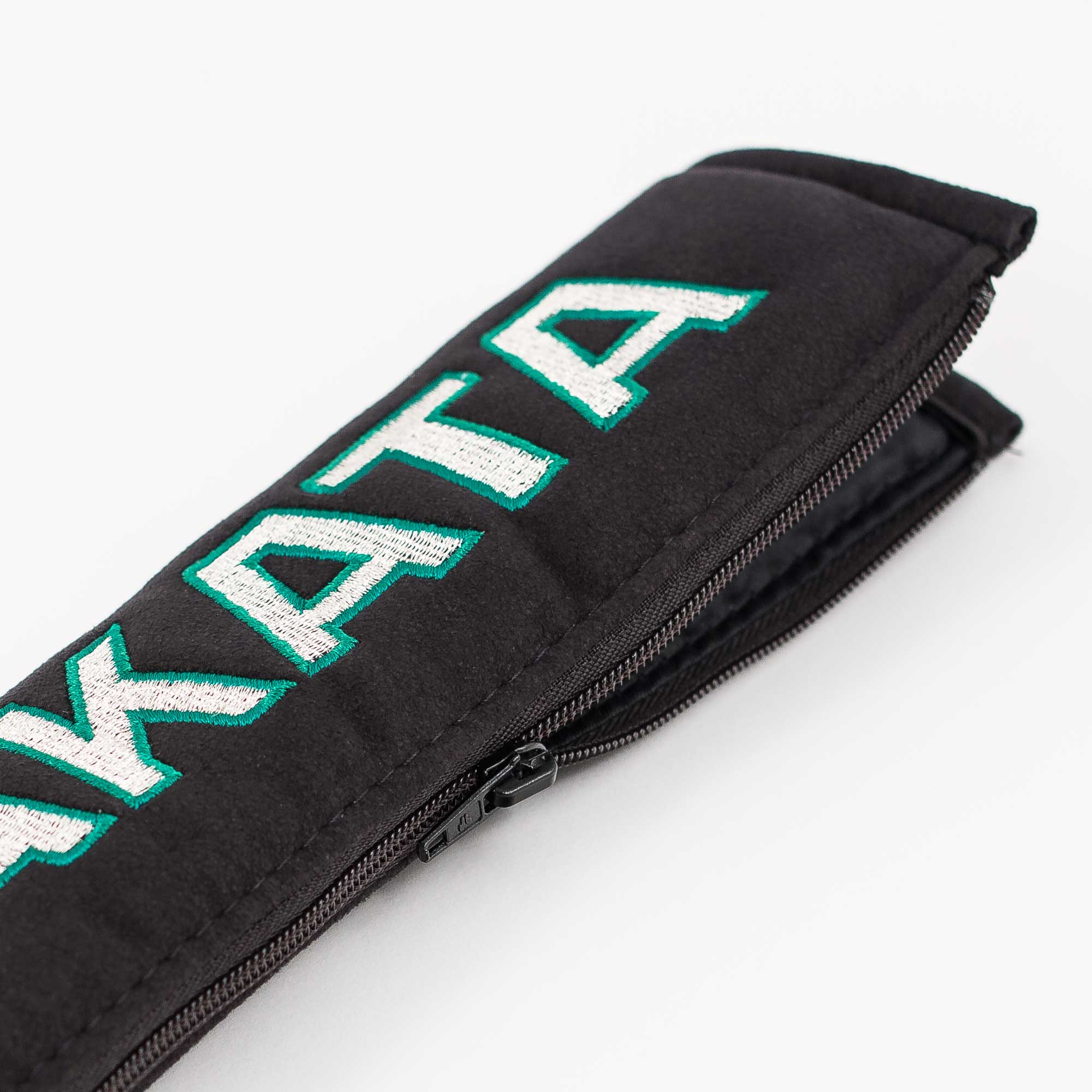 A pair of Takata comfort seat belt shoulder pads in black.