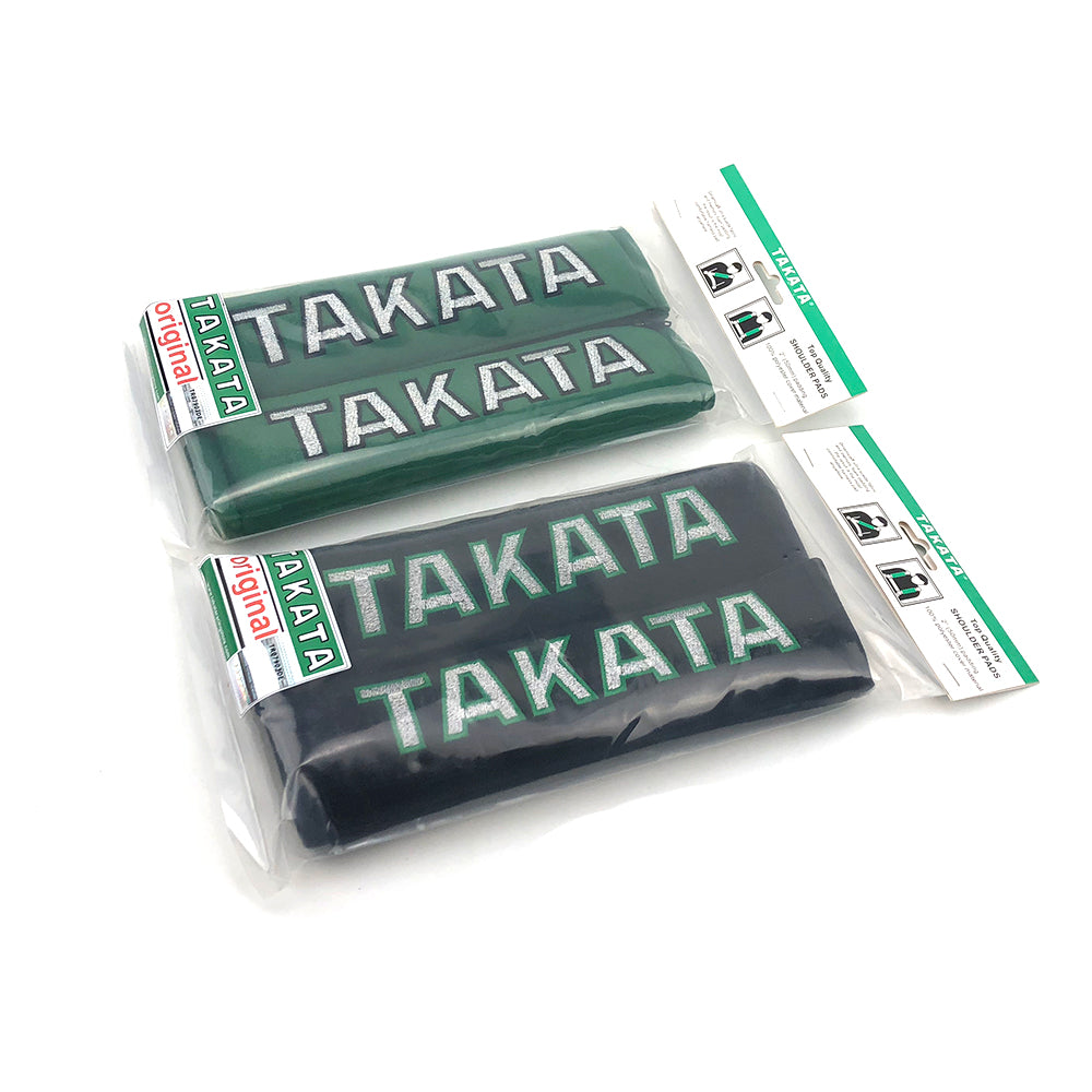 A pair of Takata comfort seat belt shoulder pads in black and green.