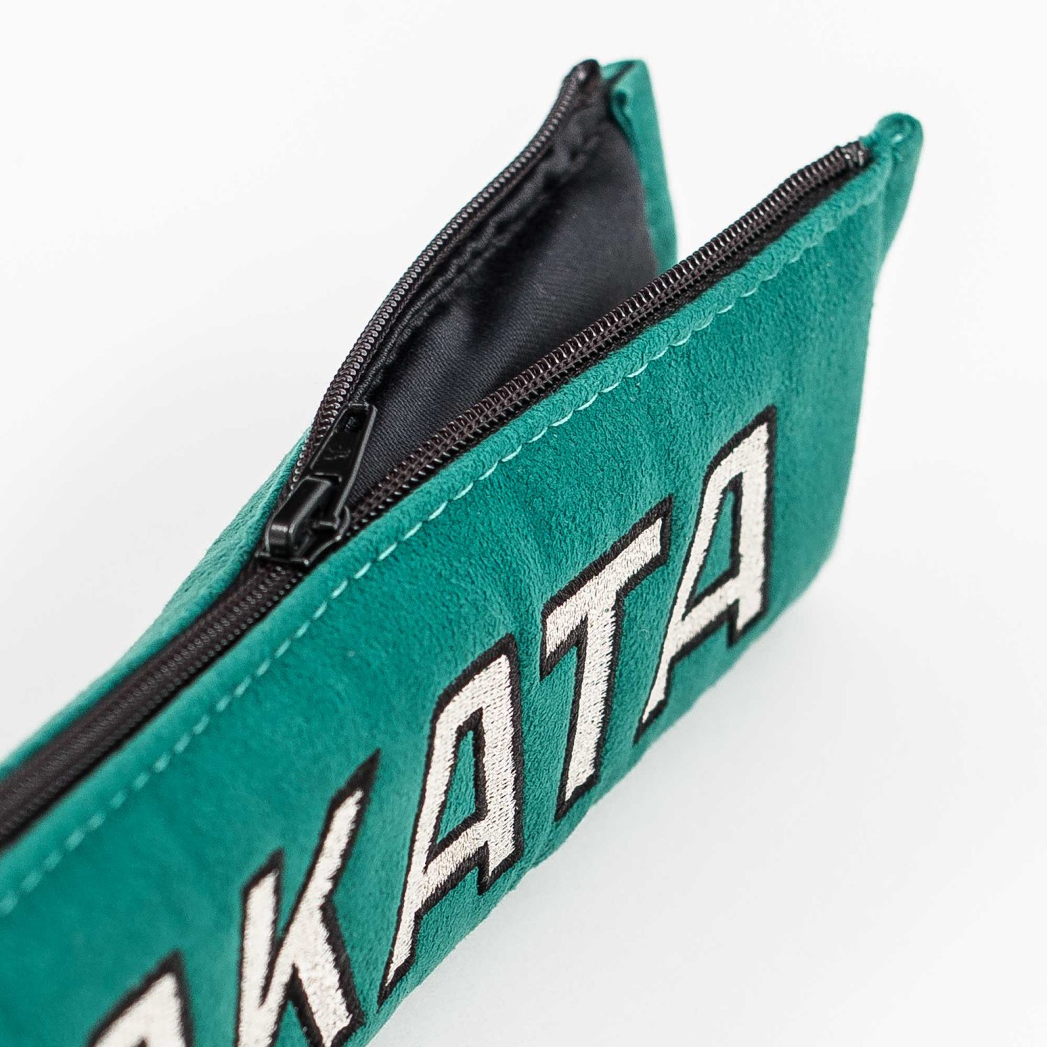 Fabric details of takata comfort seat belt shoulder pads in green.