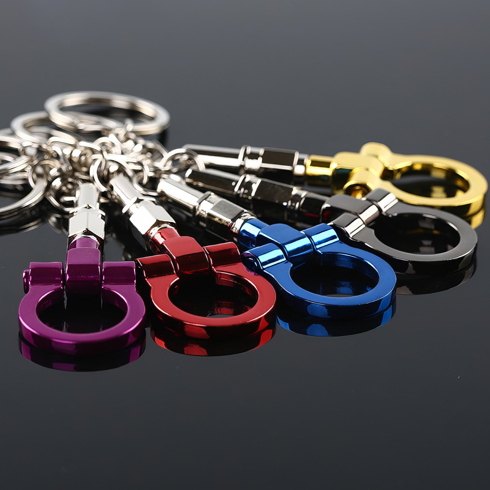 Tow hook keychains with purple, red, blue, black, and gold hooks.